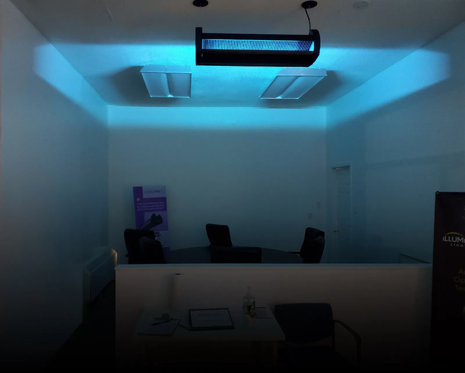 SaniLume fixture emitting germicidal UV in an upper-room treatment zone